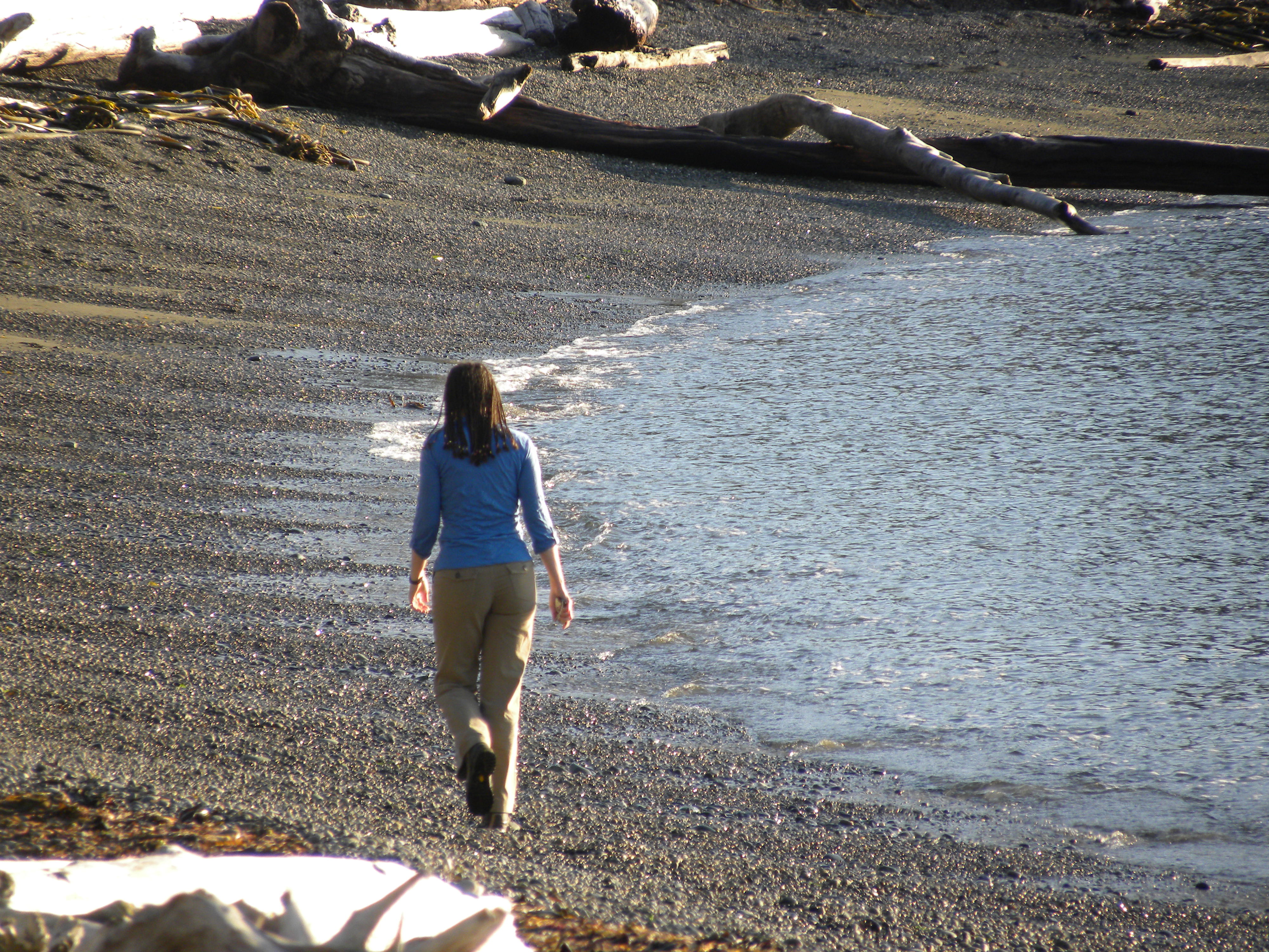 Woman walks on beach in Washington